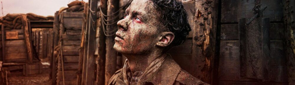 Image shows a young soldier who just experienced the trauma of trench warfare during WWI. Image is from the 2022 film.